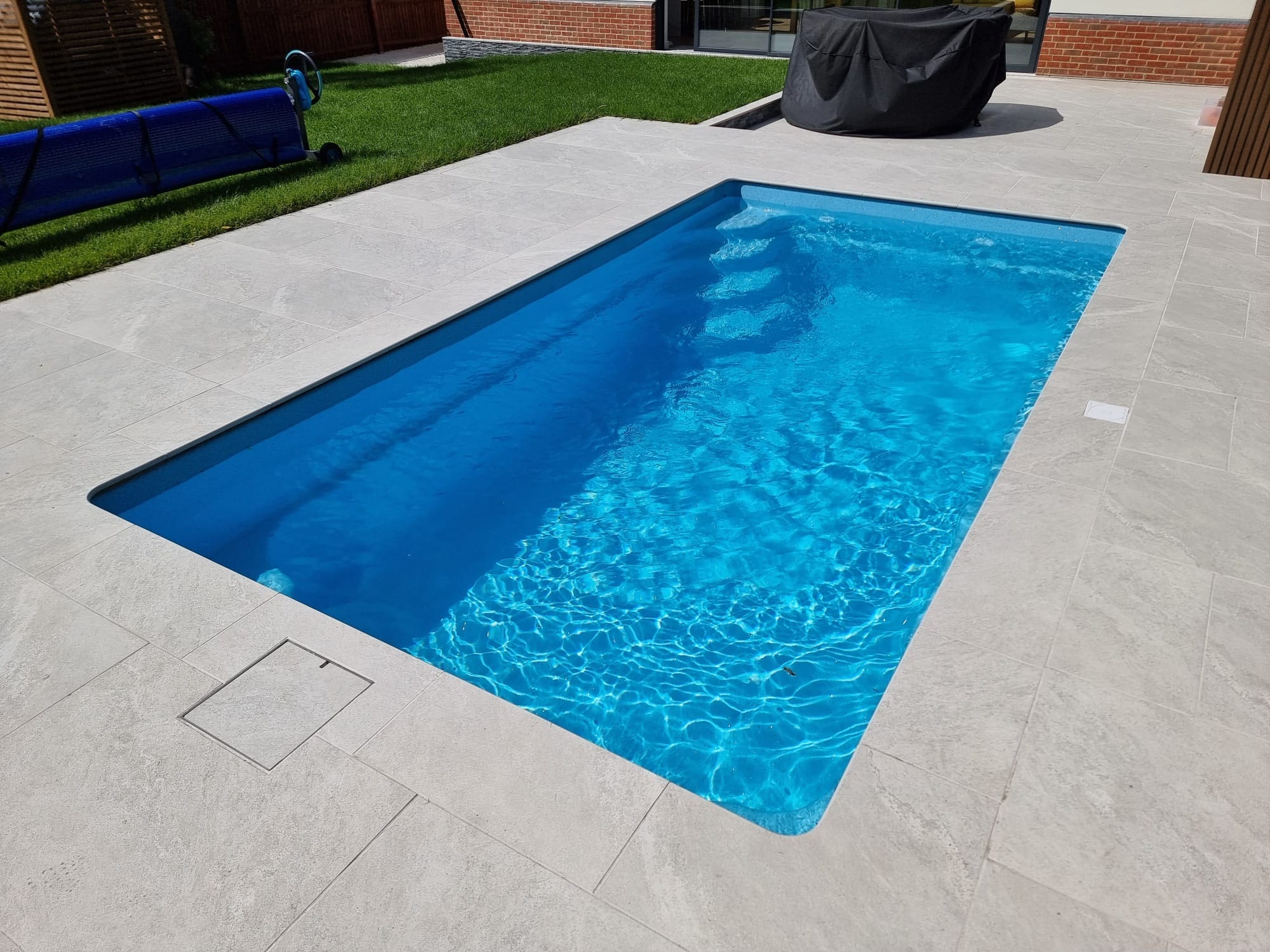 View across the swimming pool towards the property